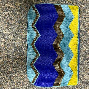 Vintage-style blue, yellow, and brown beaded clutch purse with a zipper closure